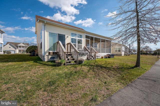 view of front facade featuring a sunroom and a front yard