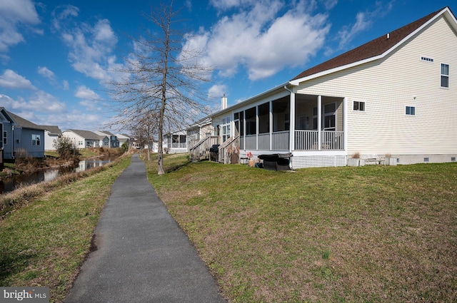 view of property exterior featuring a lawn and a sunroom