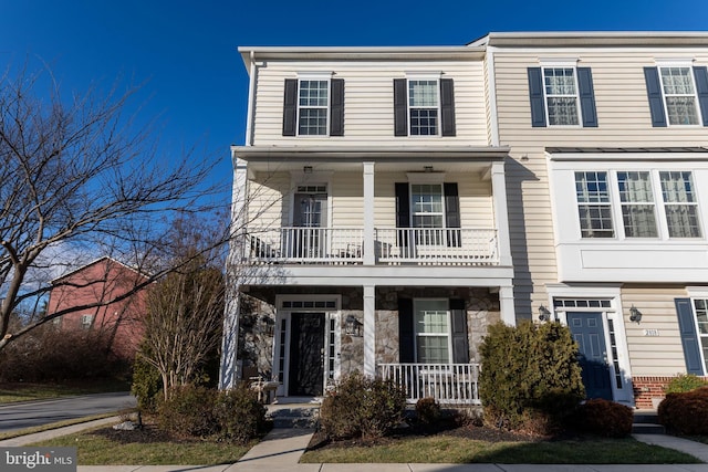 view of front of house featuring covered porch and a balcony