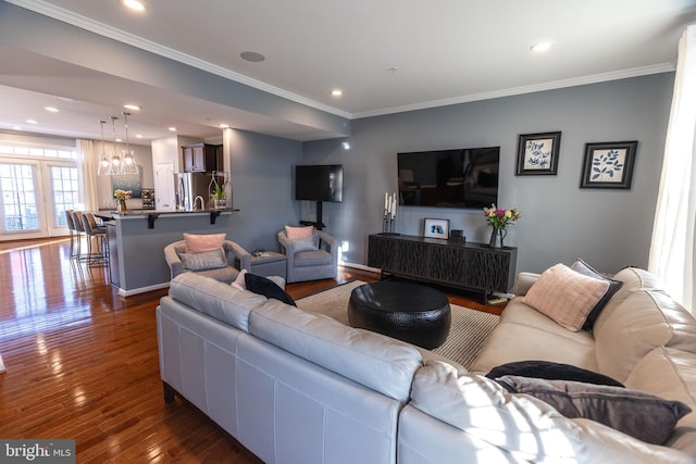 living room featuring dark hardwood / wood-style floors and crown molding