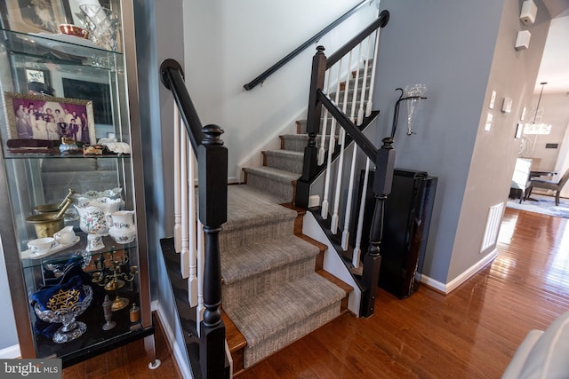 staircase with wood-type flooring