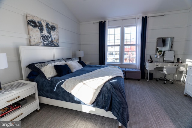 carpeted bedroom featuring lofted ceiling