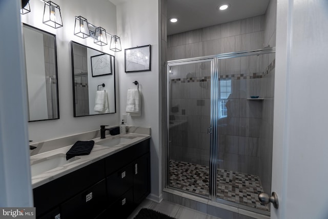 bathroom with vanity, tile patterned floors, and a shower with door