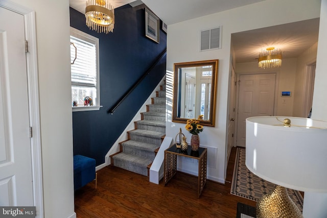 entryway with a chandelier and dark hardwood / wood-style floors