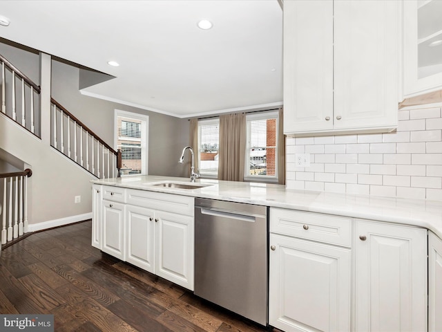 kitchen featuring dishwasher, white cabinetry, sink, ornamental molding, and dark wood-type flooring