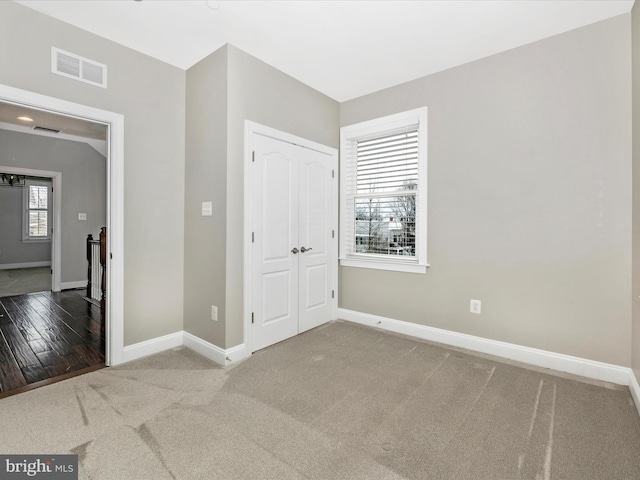 unfurnished bedroom with carpet floors and a closet