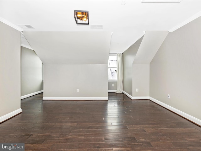 bonus room featuring vaulted ceiling and dark hardwood / wood-style floors