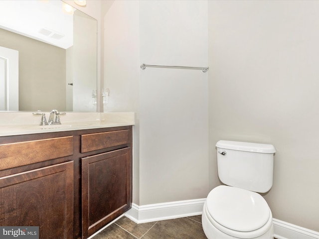 bathroom featuring toilet, tile patterned flooring, and vanity