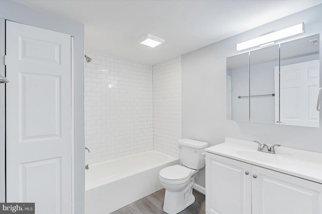 full bathroom with hardwood / wood-style flooring, vanity, toilet, and tiled shower / bath combo