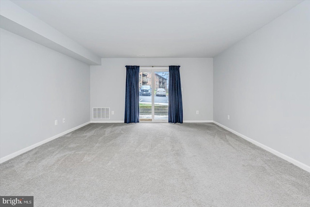 unfurnished room with light carpet