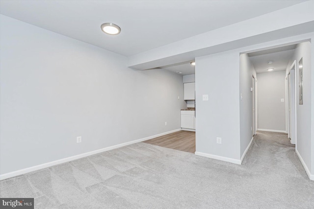 basement featuring light carpet