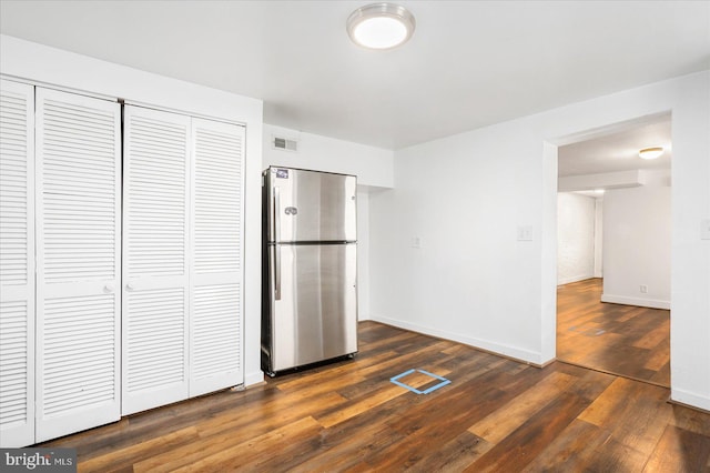 kitchen featuring dark hardwood / wood-style floors and stainless steel fridge