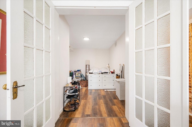 corridor with dark hardwood / wood-style flooring