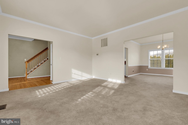 carpeted empty room with crown molding and an inviting chandelier