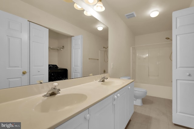 full bathroom featuring vanity, tile patterned floors, toilet, tub / shower combination, and washer / clothes dryer