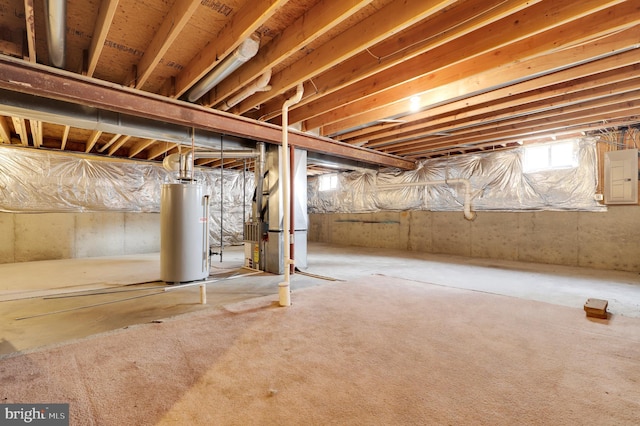 basement featuring electric panel, heating unit, and gas water heater