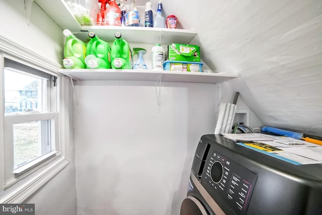 clothes washing area with washer / dryer