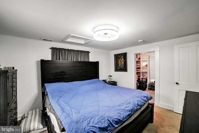 carpeted bedroom featuring a walk in closet