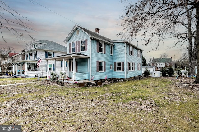 view of side of home with covered porch