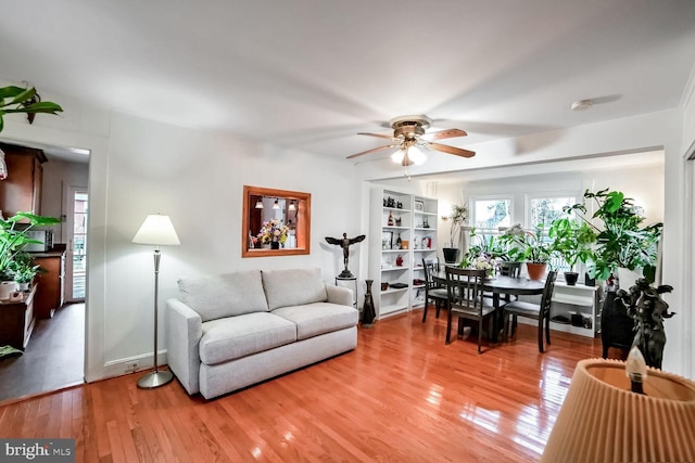 living room featuring hardwood / wood-style floors and ceiling fan