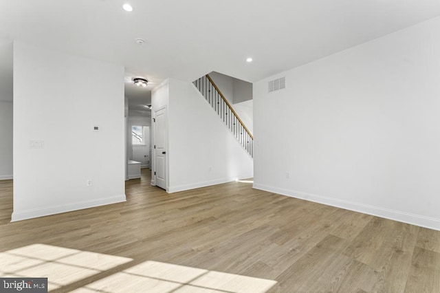 unfurnished living room with light wood-type flooring