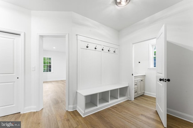 mudroom with light hardwood / wood-style floors