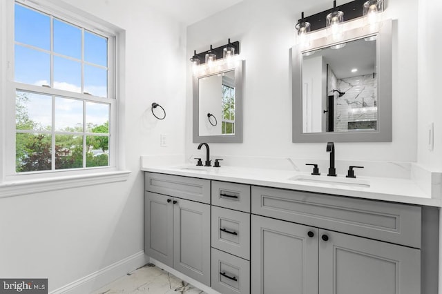 bathroom featuring vanity, a shower, and a wealth of natural light