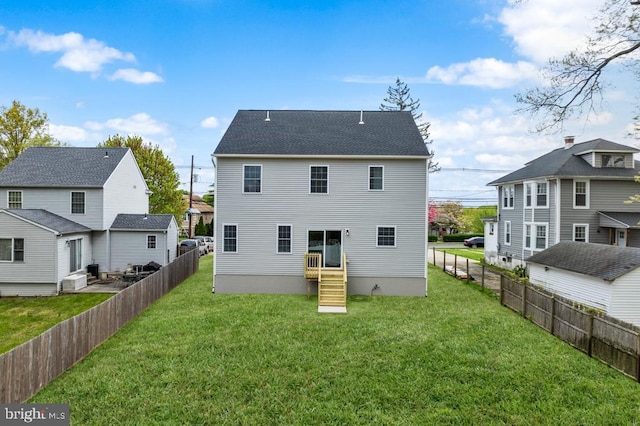 back of house with a yard