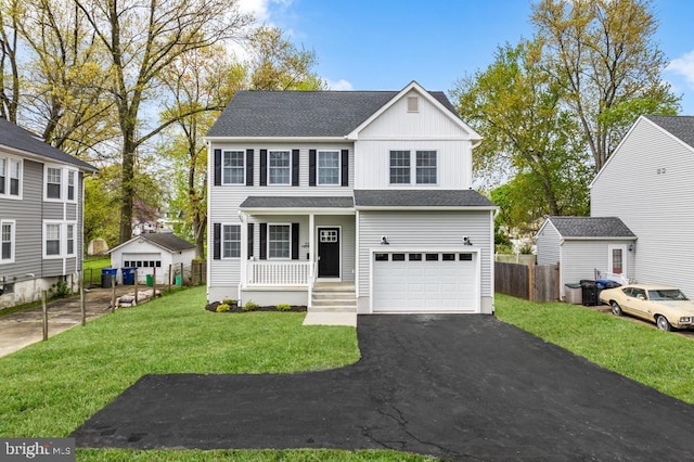 view of front facade featuring a garage, a porch, and a front yard