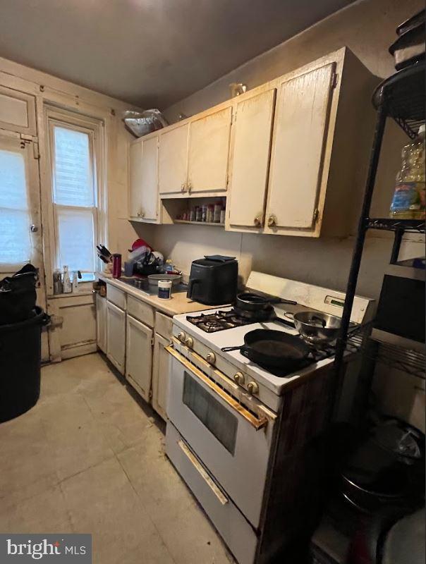 kitchen featuring white range with gas stovetop