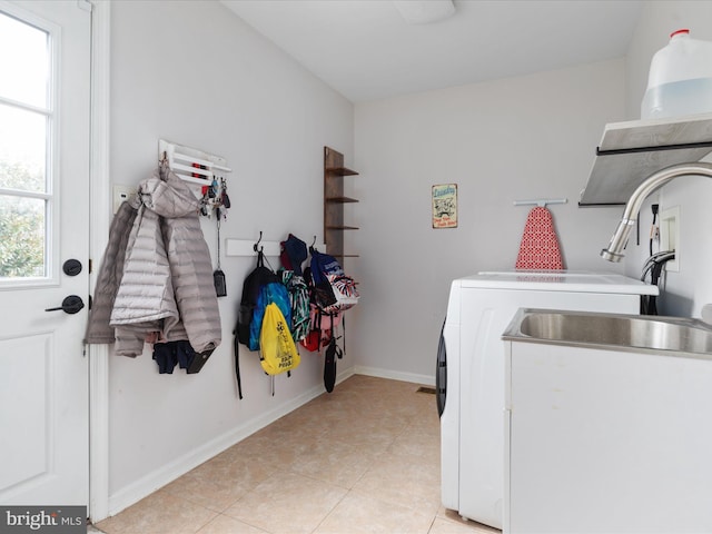 washroom with washer and dryer and light tile patterned floors