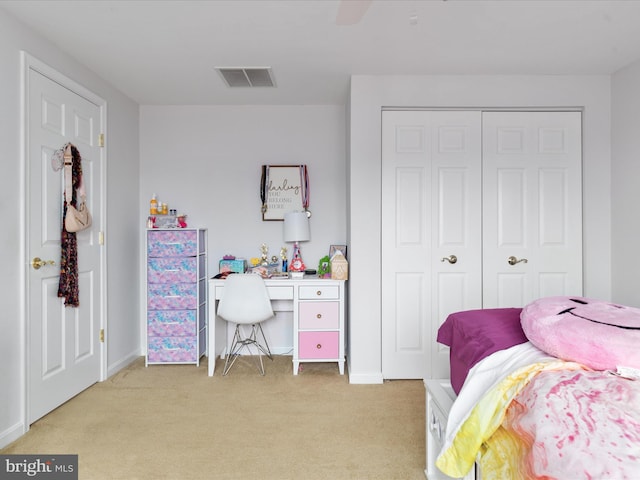 carpeted bedroom featuring a closet and ceiling fan