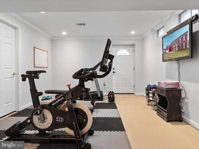 exercise room featuring crown molding