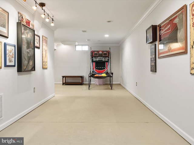 hall featuring ornamental molding and rail lighting