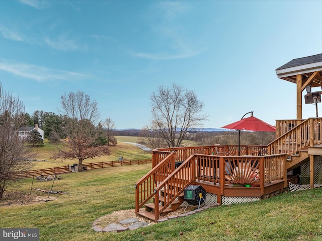 view of yard featuring a rural view and a deck