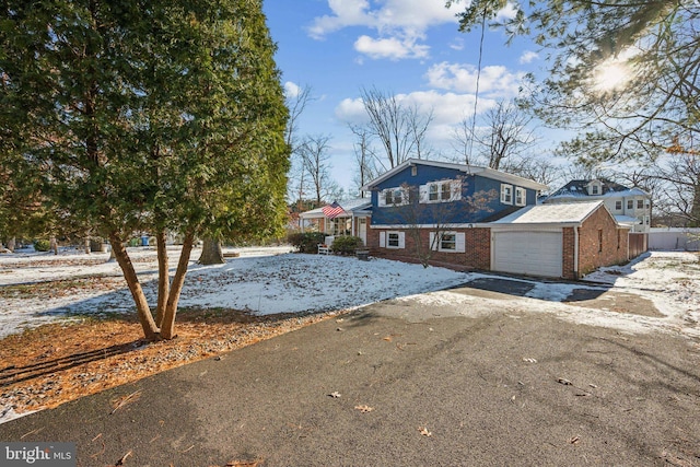 view of front of home with a garage and an outdoor structure