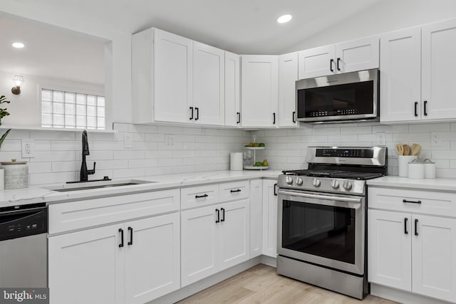 6136 Sinbad Pl, Columbia, MD 21045 - kitchen with white cabinetry, sink, light stone countertops, and appliances with stainless steel finishes