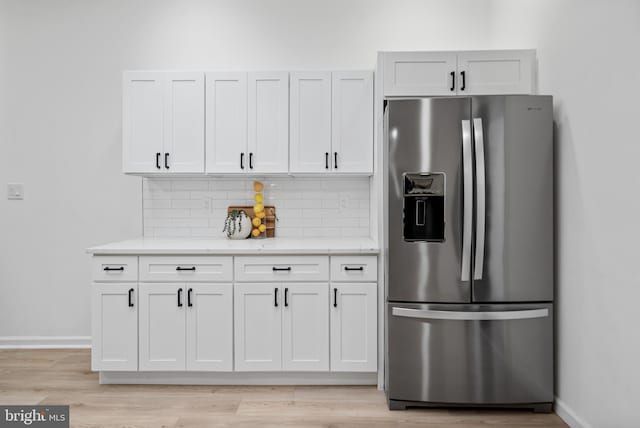 6136 Sinbad Pl, Columbia, MD 21045 - kitchen featuring white cabinetry, stainless steel fridge, and tasteful backsplash