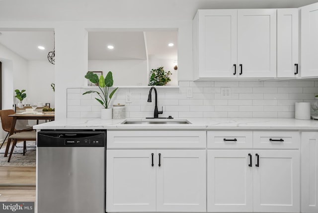 6136 Sinbad Pl, Columbia, MD 21045 - kitchen with white cabinetry, sink, stainless steel dishwasher, and light stone counters