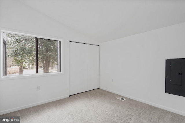 6136 Sinbad Pl, Columbia, MD 21045 - unfurnished bedroom with vaulted ceiling, light carpet, electric panel, and a closet