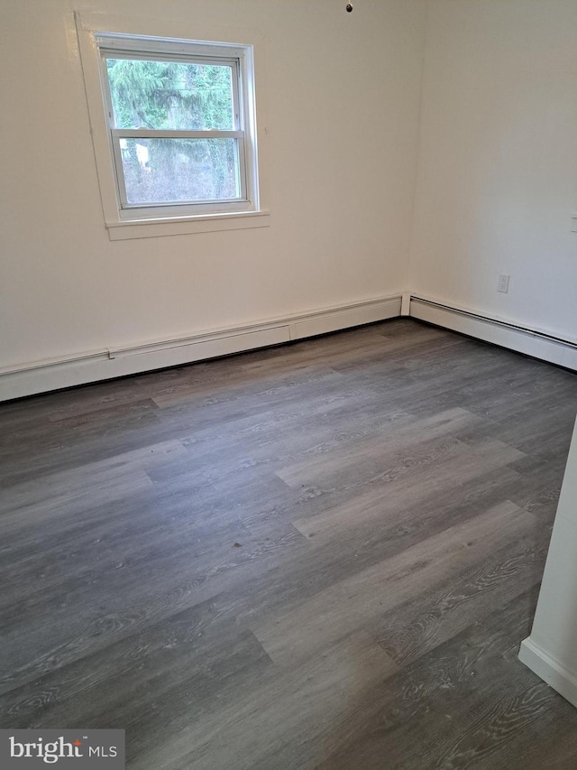 spare room featuring dark hardwood / wood-style floors