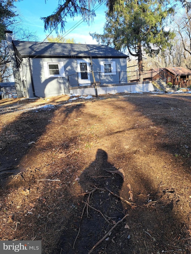 back of property featuring a wooden deck