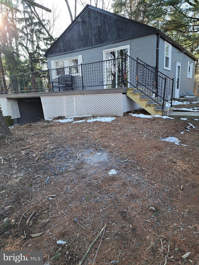 rear view of property featuring a deck