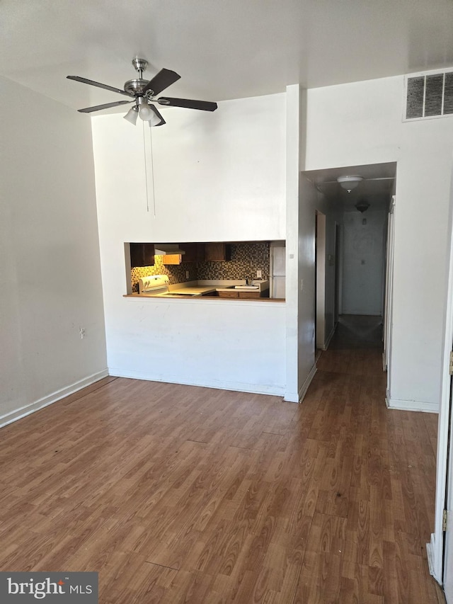 unfurnished living room featuring dark hardwood / wood-style floors and ceiling fan