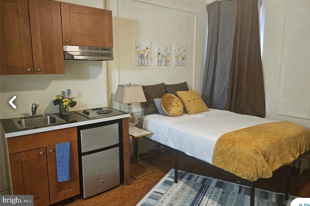 bedroom featuring dark hardwood / wood-style flooring and sink