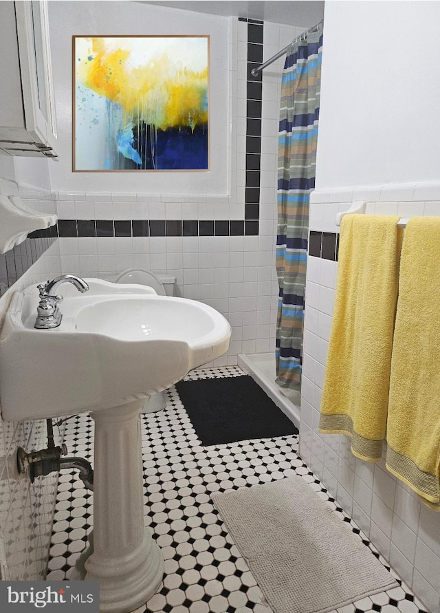 bathroom featuring tile patterned flooring, tile walls, and a shower with shower curtain