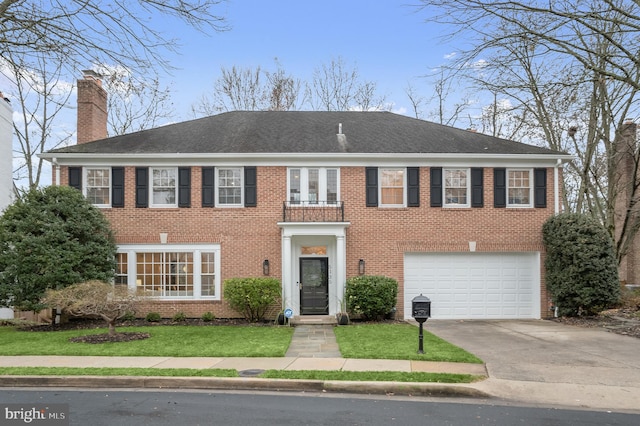 colonial house with a garage and a front lawn