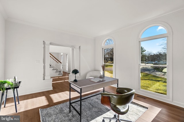 home office featuring decorative columns, crown molding, plenty of natural light, and dark wood-type flooring