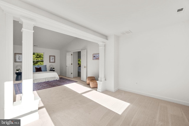 unfurnished bedroom featuring light carpet and vaulted ceiling