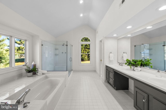 bathroom with tile patterned flooring, vanity, vaulted ceiling, and independent shower and bath